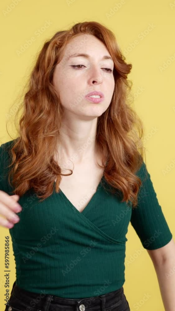 Woman with redhead hair gesturing that she is forgetting something Woman with redhead hair gesturing that she is forgetting something