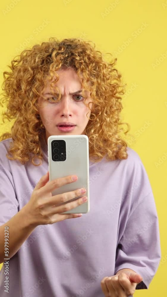 Worried woman with curly hair using a mobile Worried woman with curly hair using a mobile