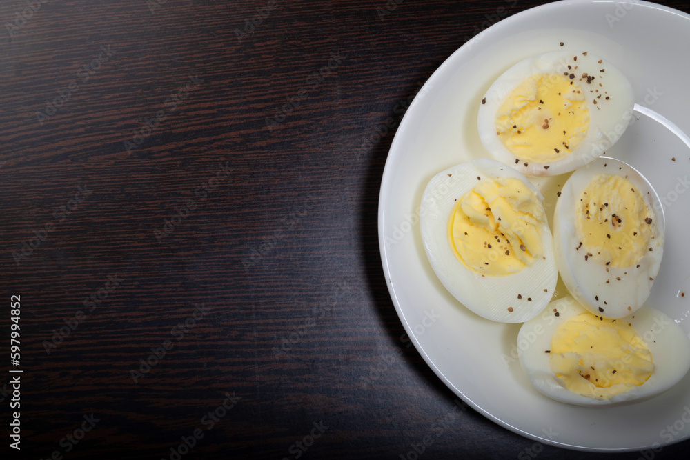 Boiled egg with seasoned black pepper in plate with text space Boiled egg with seasoned black pepper in plate with text space