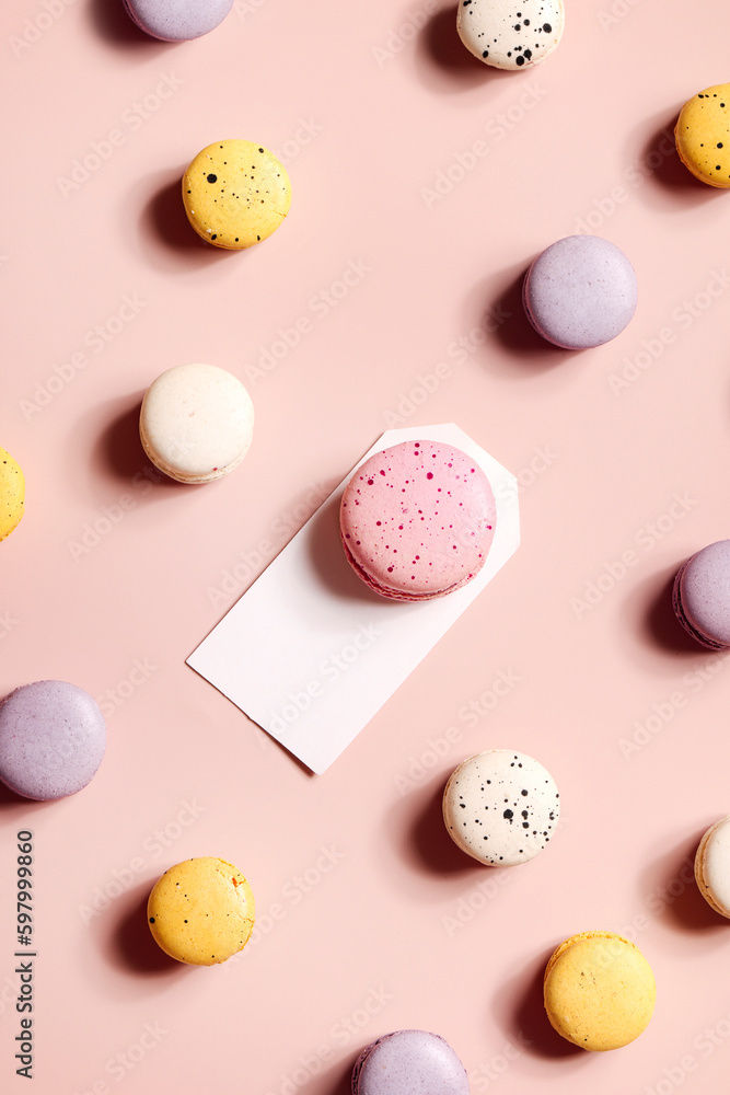 Fototapeta premium Holiday concept. card for invitation, anniversary , birthday party. frame, mockup copy space. colorful macaroons on beige background.