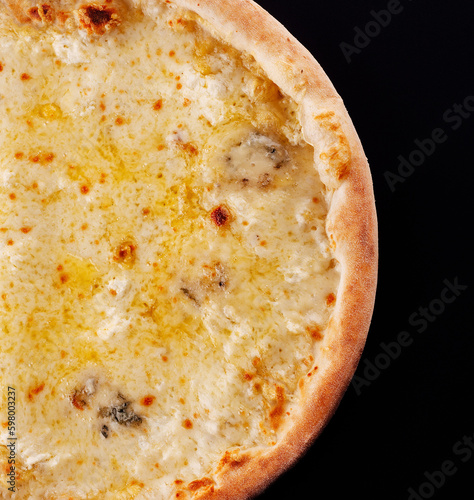 Pizza four cheeses on a black background