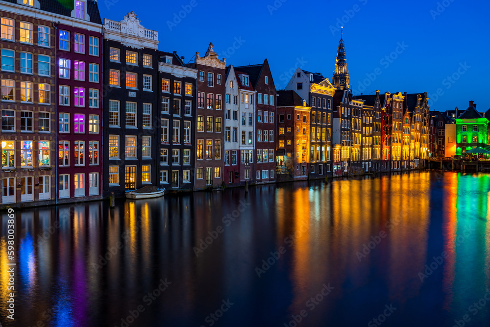 Traditional Dutch housed by the canal in Amsterdam at night, Holland