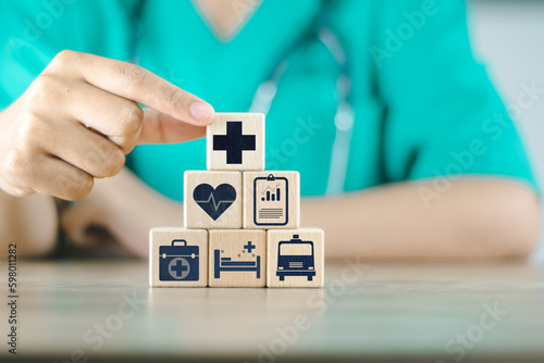 doctor doing a row wood cube block with healthcare medical to plan buy insurance wellnes life comprehensive hospital drug pharmacy ambulance including family money investment retirement