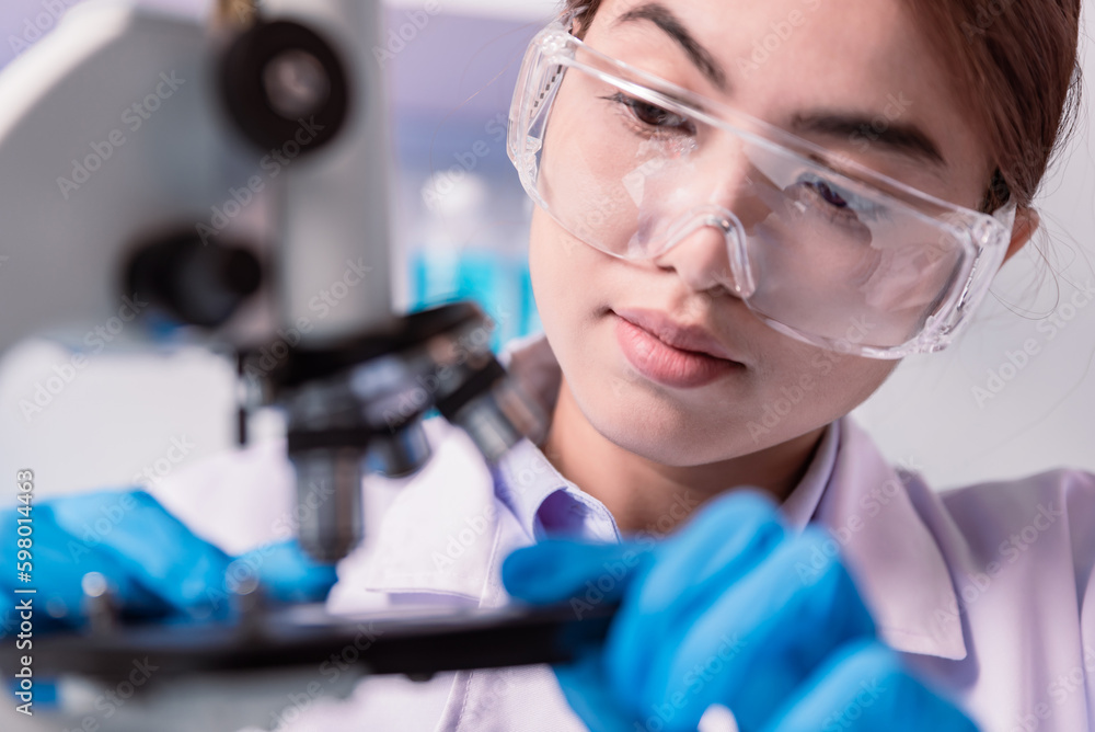 chemist,scientist hands with gloves set the sample in the microscope for research , science research and development concept chemist,scientist hands with gloves set the sample in the microscope for research , science research and development concept