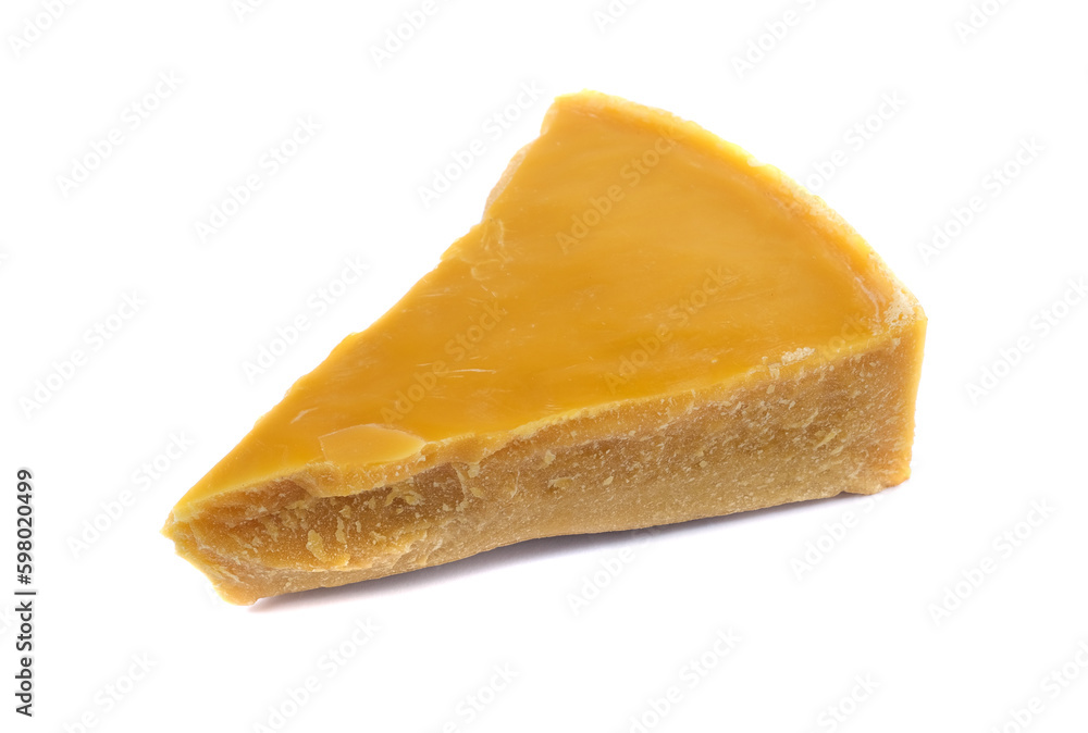A piece of natural beeswax on a white background.