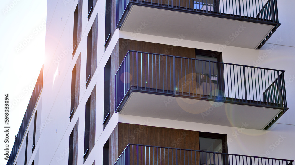 Modern apartment buildings on a sunny day with a blue sky. Facade of a modern apartment building. Contemporary residential building exterior in the daylight. Modern apartment buildings on a sunny day with a blue sky. Facade of a modern apartment building. Contemporary residential building exterior in the daylight.