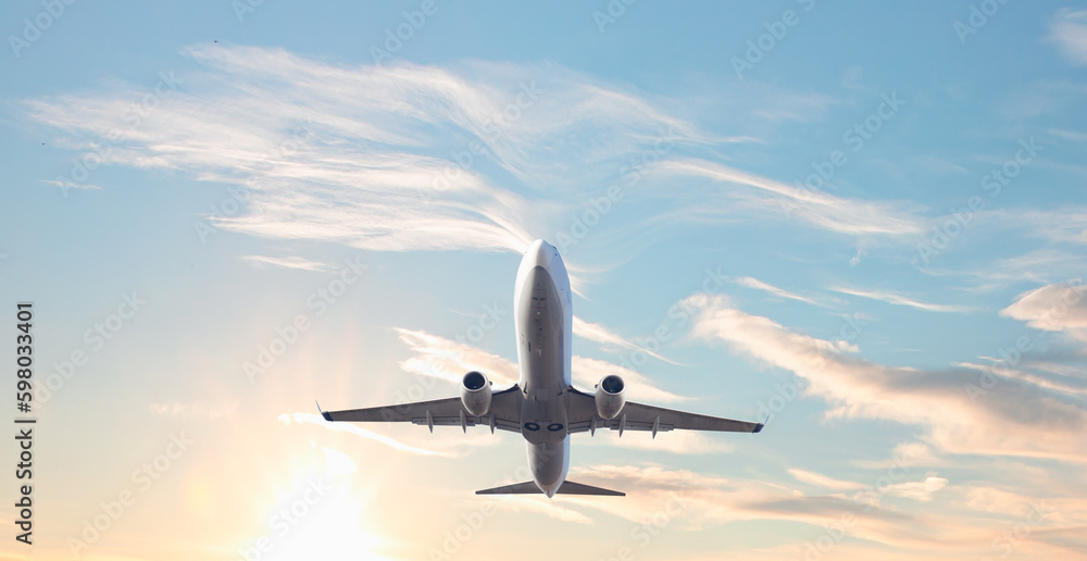 White passenger airplane flying in the sky amazing clouds in the background - Travel by air transport