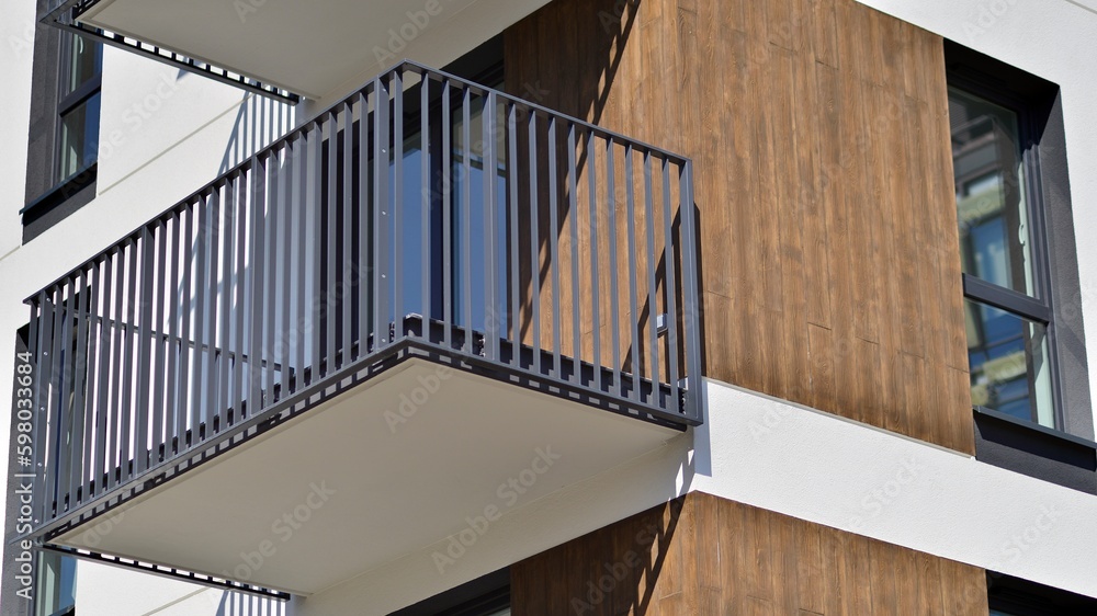 Fototapeta premium Modern apartment buildings on a sunny day with a blue sky. Facade of a modern apartment building. Contemporary residential building exterior in the daylight. 