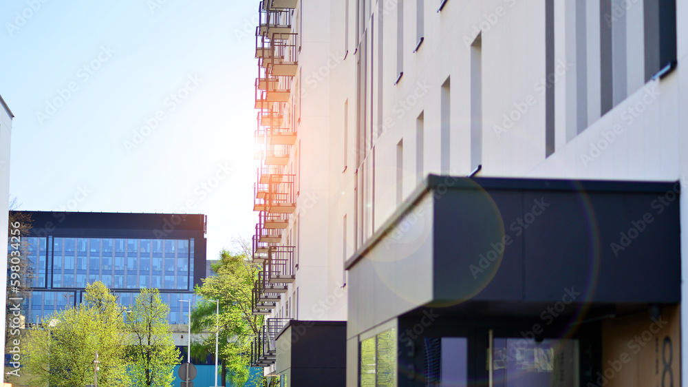 Ecology and green living in city, urban environment concept. Modern apartment building and green trees. Ecological housing architecture. A modern residential building in the vicinity of trees. Ecology and green living in city, urban environment concept. Modern apartment building and green trees. Ecological housing architecture. A modern residential building in the vicinity of trees.