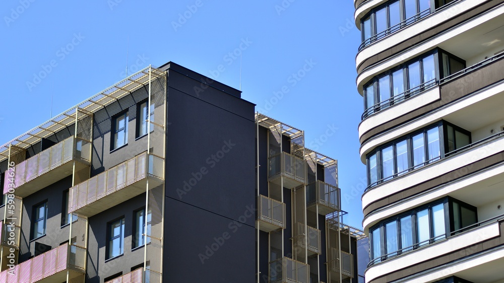 Modern apartment buildings on a sunny day with a blue sky. Facade of a modern apartment building. Contemporary residential building exterior in the daylight. 