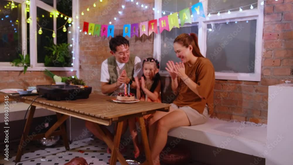 Happiness asian father and mother celebrate birthday with daughter while blow candle, mom and dad and kid in party with excited and surprise, relation and bonding, lifestyles concept. Happiness asian father and mother celebrate birthday with daughter while blow candle, mom and dad and kid in party with excited and surprise, relation and bonding, lifestyles concept.