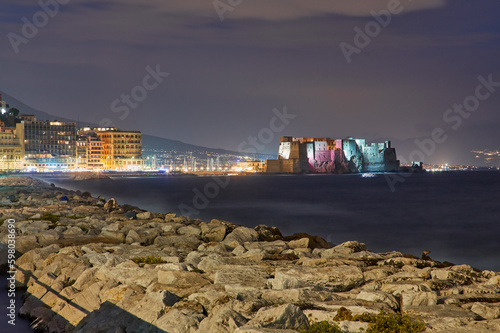 Castel dell Ovo Egg castle in Naples, Italy, view from the seaside quay in evening light photo