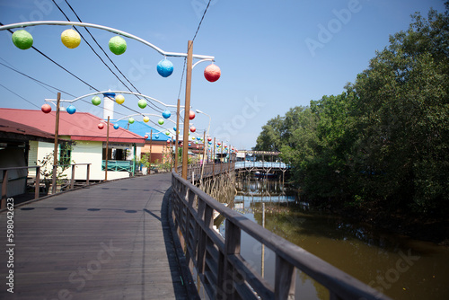 wooden brigde at Bontang Kola Village and the mangrove forest, Bontang, East Kalimantan, Indonesia photo