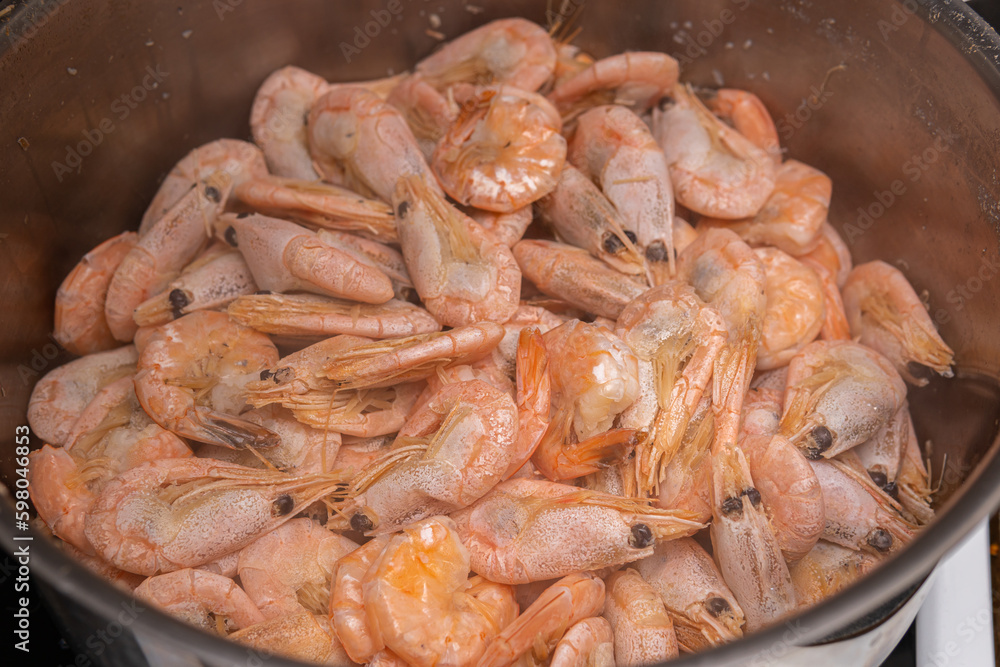 A lot of big shrimps, prawns are being cooked in the cooker A lot of big shrimps, prawns are being cooked in the cooker
