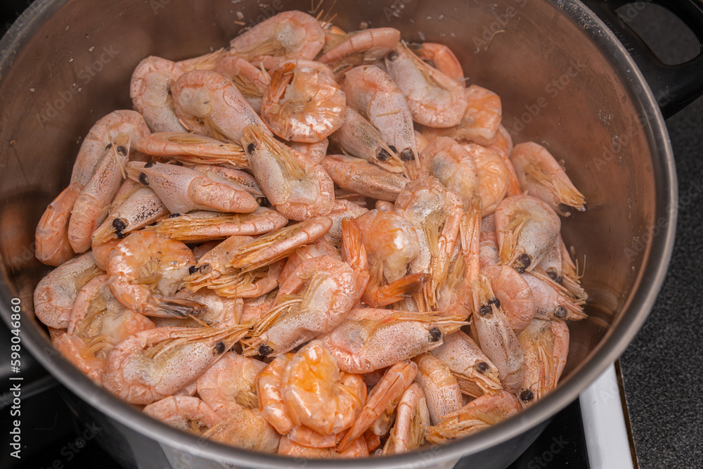 A lot of big shrimps, prawns are being cooked in the cooker A lot of big shrimps, prawns are being cooked in the cooker