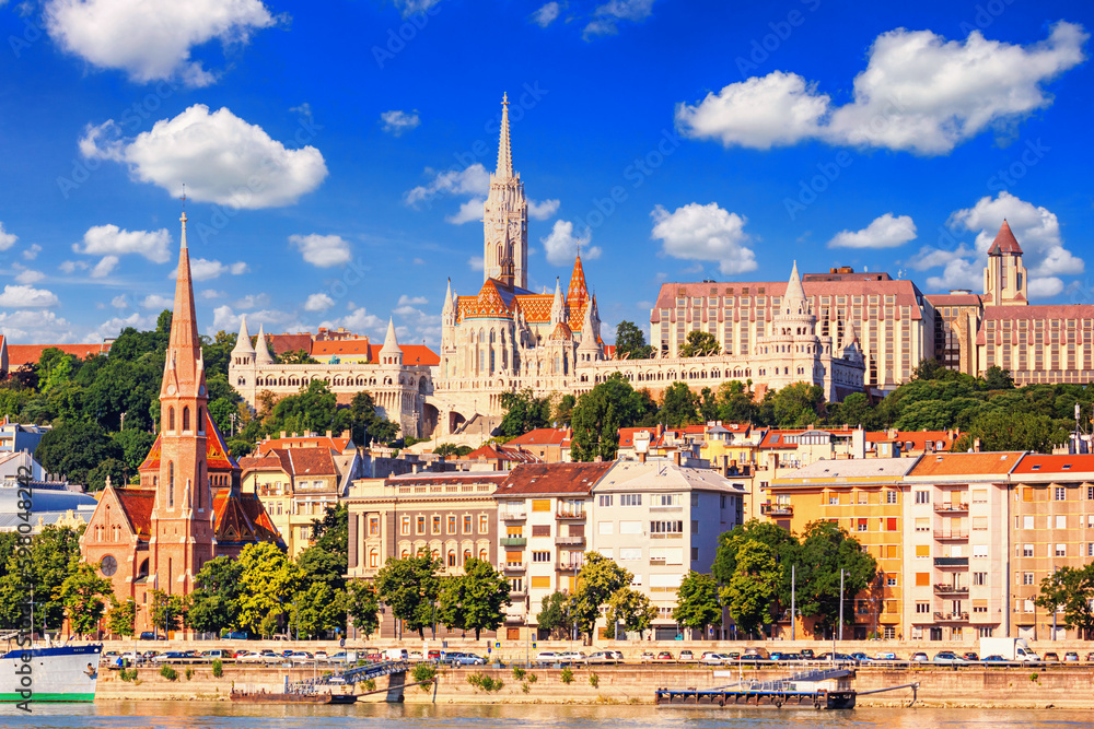 Naklejka premium City summer landscape - view of the Buda Castle, palace complex on Castle Hill with Matthias Church over the Danube river in Budapest, Hungary