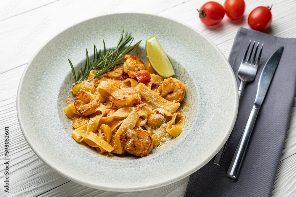 delicious pasta in a plate on a white wooden table. close-up
delicious pasta in a plate on a white wooden table. close-up