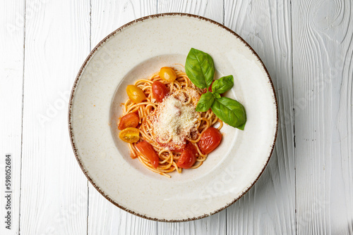 delicious pasta in a plate on a white wooden table. close-up 
