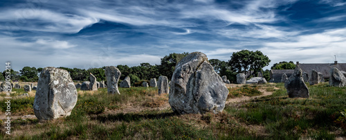 Ancient Stone Field Alignements De Menhir Carnac With Neolithic Megaliths And Old Cottage In Brittany, France
