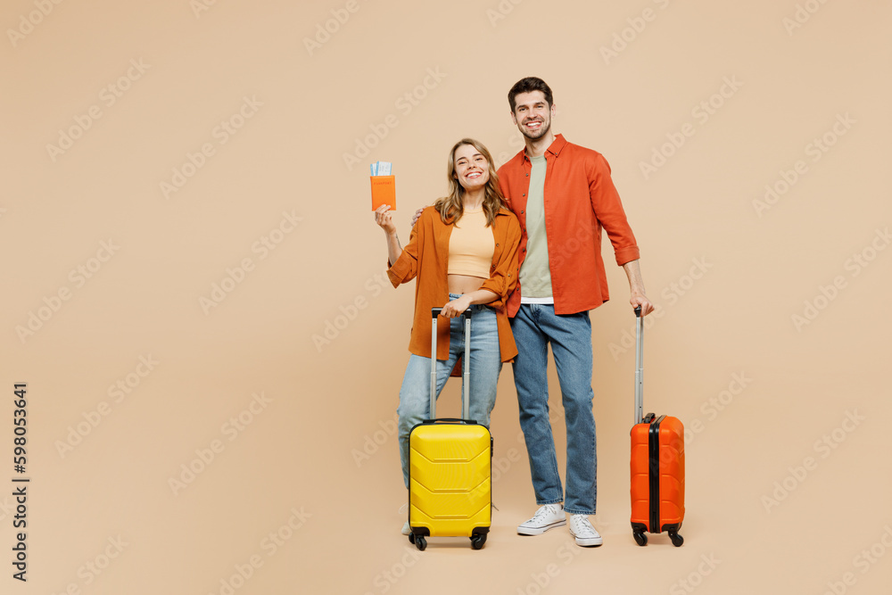Φωτογραφία Traveler couple two friend family man woman wearing casual clothes hold passport ticket bag isolated on plain beige background Tourist travel abroad in free time rest getaway