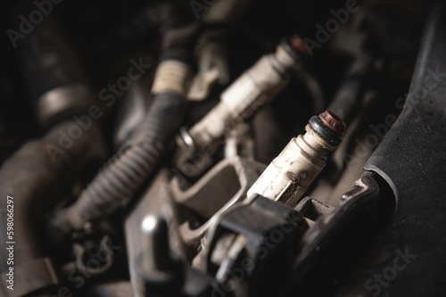 Old dirty injectors on the fuel rail in selective focus