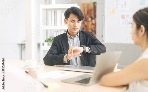 Business man looking time watch for worried for late meeting time