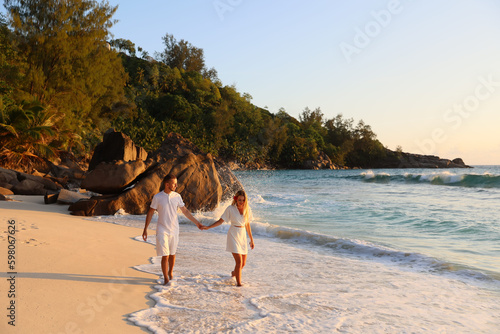 Photography beautiful couple of lovers walks the Seychelles against the background of stones
