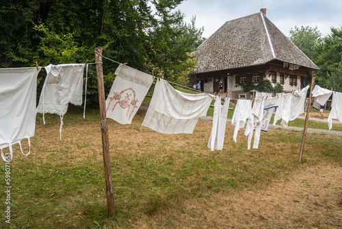 Hanging clothes in front of a traditional farmhouse at Black Forest Open Air Museum in Gutach, Schwarzwald, Germany
