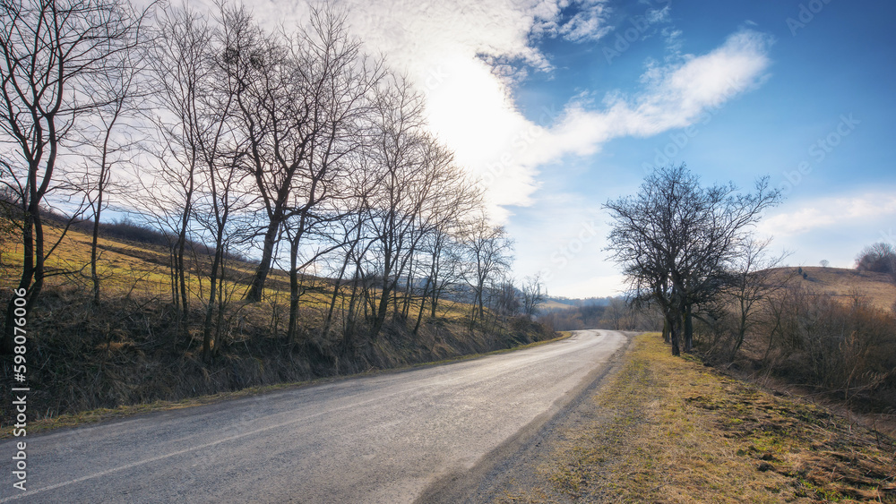 early days of spring bring a new life to the countryside, as the road winds through the lush valley