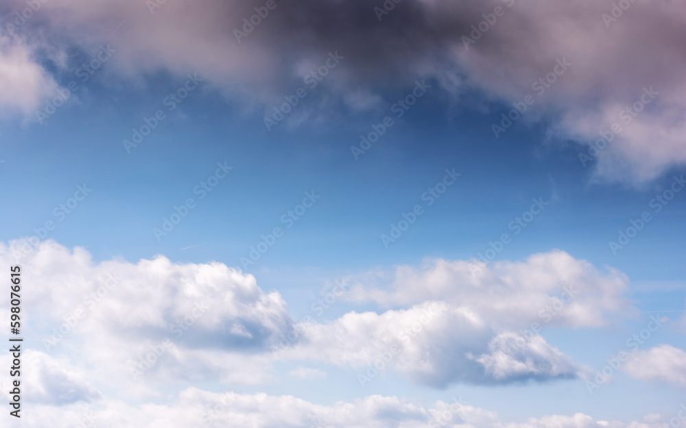 sunny weather forecast background. blue sky with white clouds above horizon in morning light
