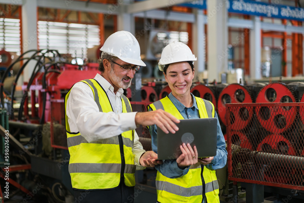 The project manager and engineers are inspecting workpieces and checking standards and safety for products and safety in the factory. Technician and Female Worker Talking on a Meeting in a Factory. The project manager and engineers are inspecting workpieces and checking standards and safety for products and safety in the factory. Technician and Female Worker Talking on a Meeting in a Factory.