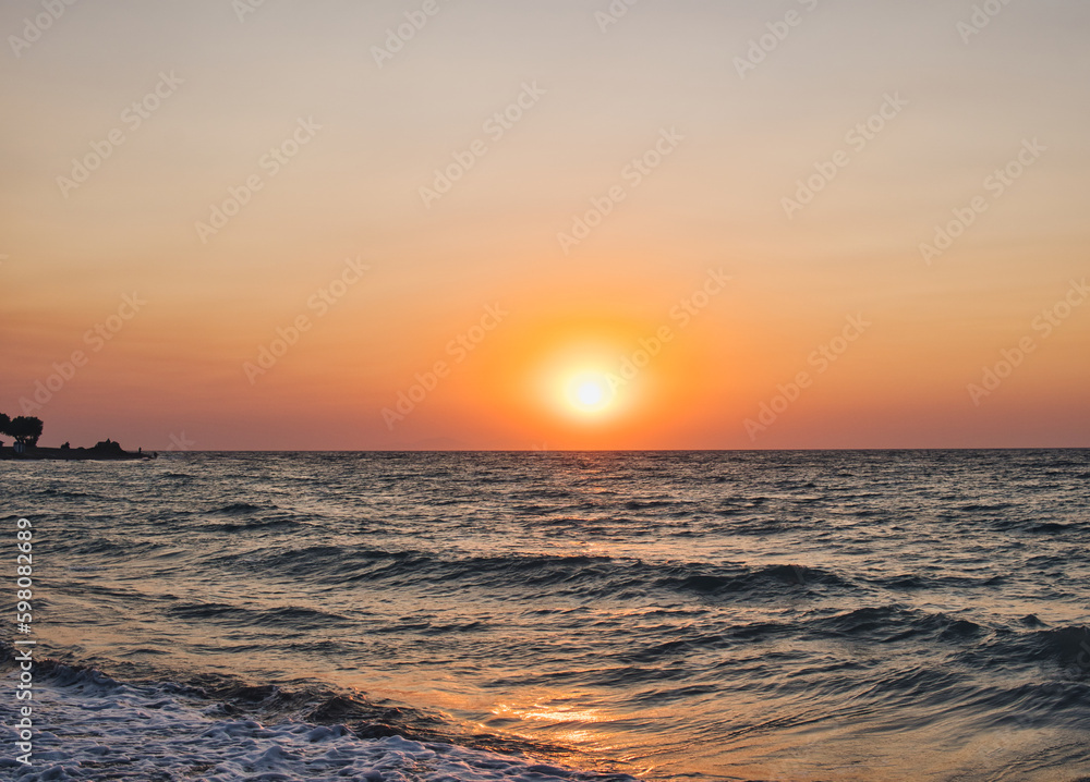 Sunset over Mediterranean Sea seen from a beach at Rhodes island