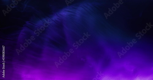 Colored smoke moves beautifully against a black background. Mockup for your logo. Wide angle horizontal wallpaper or web banner. Slow motion.