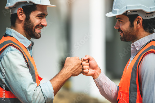 Workers at construction site, young civil engineer working together with teamwork