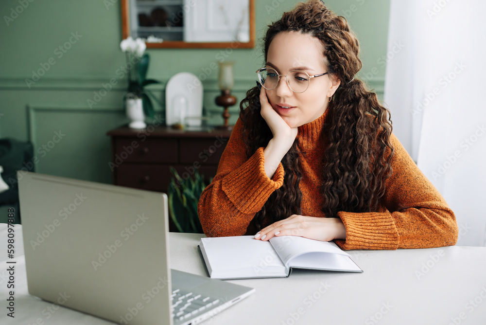 Contemplative Young Woman Taking Breaks from Online Learning and Working on Laptop at Home. Young Woman Studying and Working from Home, Lost in Thought and Contemplating Ideas on Her Laptop. Contemplative Young Woman Taking Breaks from Online Learning and Working on Laptop at Home. Young Woman Studying and Working from Home, Lost in Thought and Contemplating Ideas on Her Laptop.