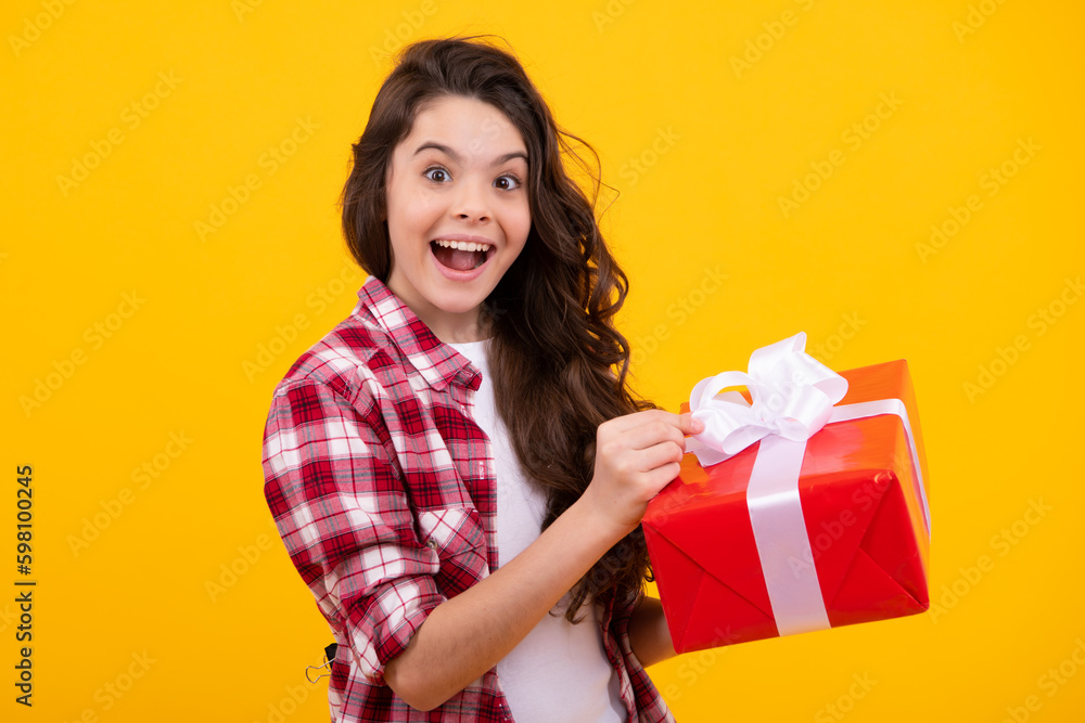 Amazed teenager. Teenager kid with present box. Teen girl giving birthday gift. Present, greeting and gifting concept. Excited children. Amazed teenager. Teenager kid with present box. Teen girl giving birthday gift. Present, greeting and gifting concept. Excited children.