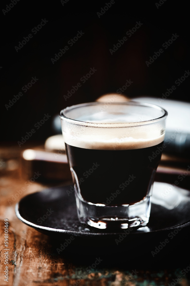 Coffee in glass cup on dark wooden background. Copy space. Coffee in glass cup on dark wooden background. Copy space.