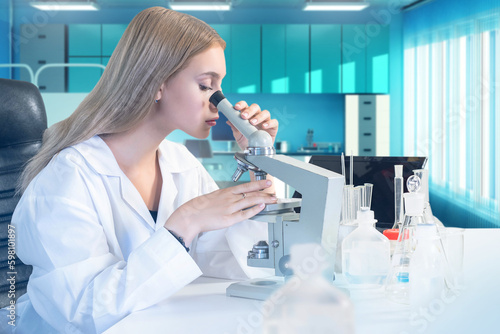 Woman biologist with micros...