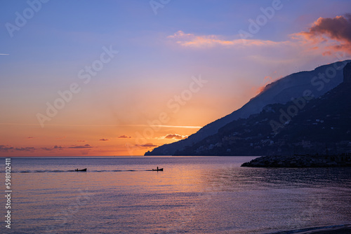 Maiori, Italy. Sunset view of the Amalfi Coast, from Maiori, while two boats are returning to the bay. 2022-12-28.
