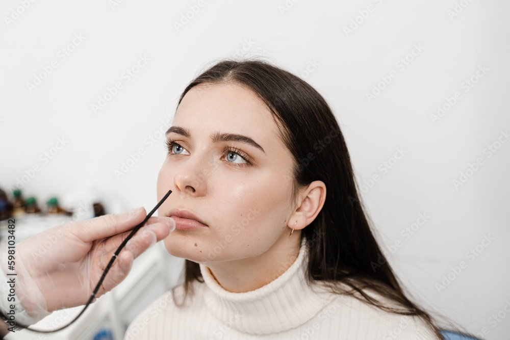 ENT specialist diagnoses and treats larynx and pharynx, such as hoarseness, vocal cord nodules, tumors, infections, and inflammation. ENT doctor using fibrolaryngoscope to examine and treat nose. ENT specialist diagnoses and treats larynx and pharynx, such as hoarseness, vocal cord nodules, tumors, infections, and inflammation. ENT doctor using fibrolaryngoscope to examine and treat nose.