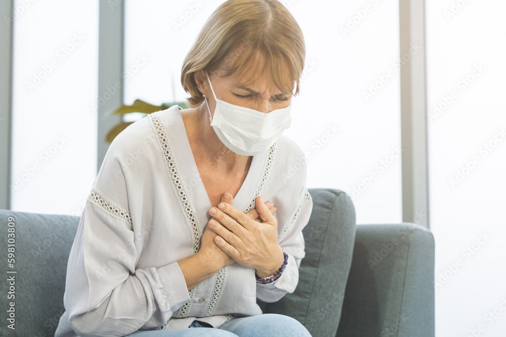 Cardiology, angina caucasian mature woman hand hold chest with pain and