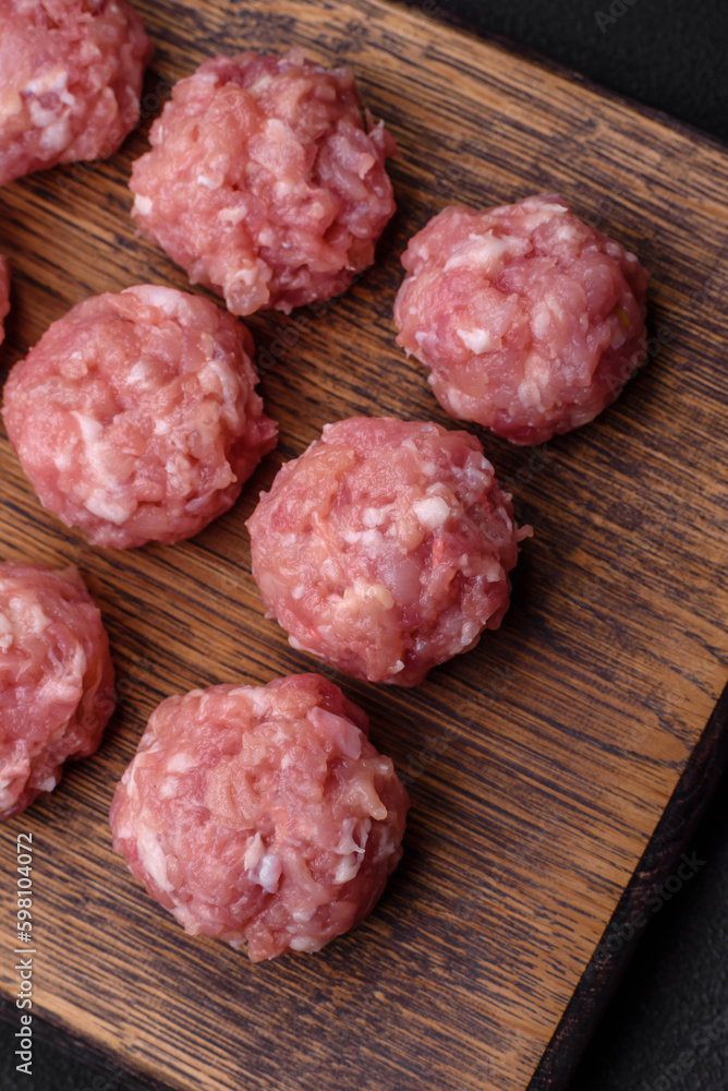Raw meatballs of minced meat beef, pork or chicken with salt, spices and herbs Raw meatballs of minced meat beef, pork or chicken with salt, spices and herbs