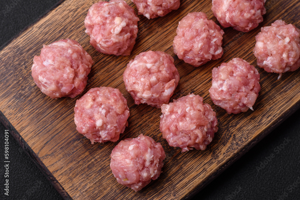Raw meatballs of minced meat beef, pork or chicken with salt, spices and herbs