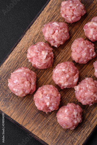 Raw meatballs of minced meat beef, pork or chicken with salt, spices and herbs