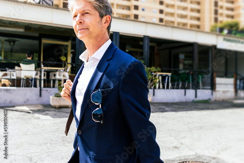 Elegant Businessman traveling with suitcase