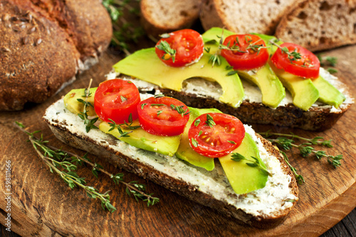Toast with cream cheese, avocado and cherry tomatoes