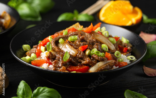 Stir fry Crispy Orange Beef with sweet peppers, onion and rice. Asian food