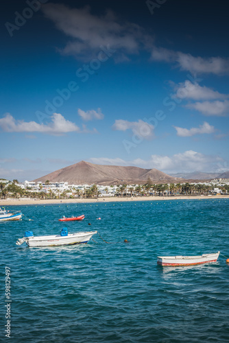 Fishing boats in turquoise sea near Costa Teguise, Lanzarote, Canary Islands © Anastasija