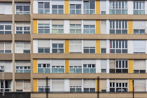 Facade of a constructivist house with windows in the style of the seventies with yellow panels