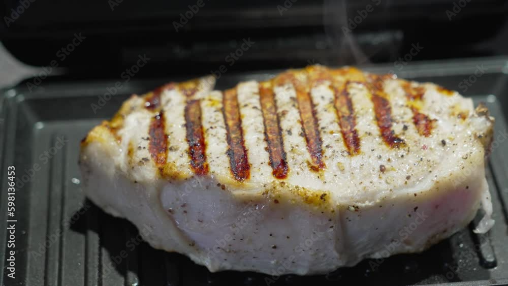 meat steak is fried on a small home electric grill. multi-baker. Generative AI meat steak is fried on a small home electric grill. multi-baker. Generative AI